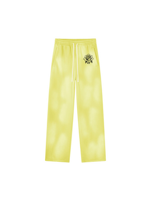 Yellow Baggy Sun Faded Y2K Sweatpants laid flat, front view with white drawstring and small black rose print