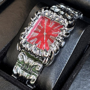 Silver baroque watch with a rectangular red dial and Roman numerals