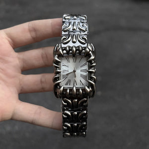 Silver baroque watch with a rectangular red dial and Roman numerals