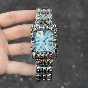 Silver baroque watch with a rectangular red dial and Roman numerals