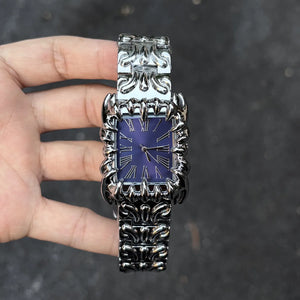Silver baroque watch with a rectangular red dial and Roman numerals