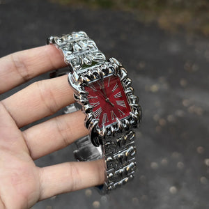 Silver baroque watch with a rectangular red dial and Roman numerals
