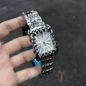 Silver baroque watch with a rectangular red dial and Roman numerals