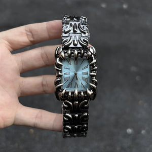 Silver baroque watch with a rectangular red dial and Roman numerals