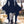 Navy blue goth mini dress with long bat wing sleeves, worn with fishnet tights and lace-up boots
