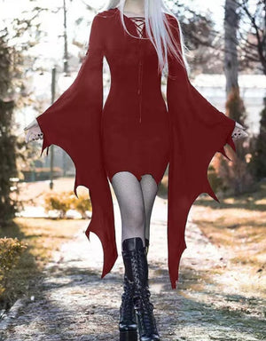 Dark red bat wing mini dress with a lace-up V neck and lace frills at the wrists, front view outdoors