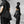 Black Hooded Techwear Windbreaker folded and slung across the body on its strap, worn like a shoulder bag