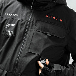 Chest of the Black Hooded Techwear Windbreaker: red lettering, grey markings, flap pocket and full front zip