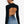 Back view of the black long sleeve crop top, bare upper back and a thin black tie over high-waisted jeans