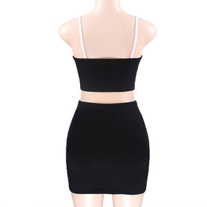 Back view on a mannequin of the black Y2K skirt set, spaghetti straps, cropped back and plain black skirt
