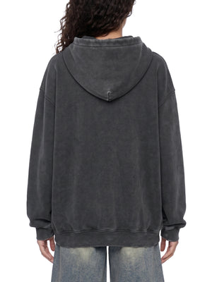 Model seen from behind in the Black Y2K Skull Hoodie, oversized body worn over baggy jeans