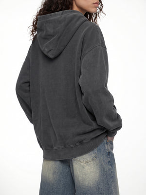 Three-quarter back view with both hands in the kangaroo pocket of the Black Y2K Skull Hoodie