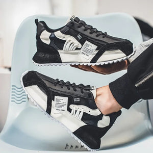 Breathable mesh techwear sneakers worn with slim trousers, styling shot