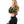 Side view of the camouflage crop hoodie with the model looking back, long sleeve and short hem above black shorts
