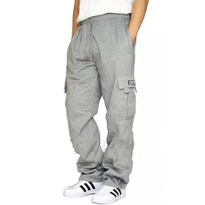 Grey men's sweatpants with a drawstring waist and side cargo pocket, front view with hands in pockets