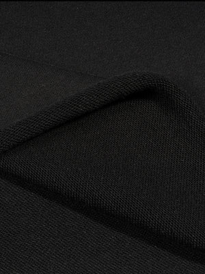 The hem folded back to show the loop-back face of the fabric on the inside of the garment