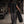 Seen from behind carrying a tyre, the dropped armhole leaving the whole shoulder and arm free
