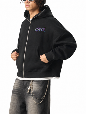 Side view of the Chrome Y2K Zip Up Hoodie over washed grey jeans, showing the curved front pockets