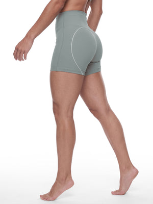 The model walking in the haze blue shorts, seen from the back, the trim following the curve of the seat