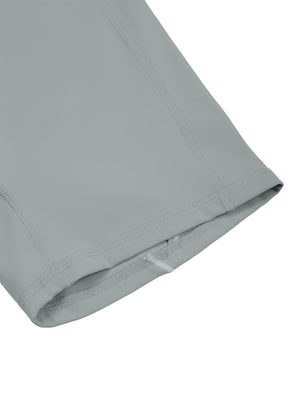 Close-up of a leg hem, folded under and stitched flat on the thin haze blue fabric