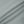 Close-up of the smooth haze blue nylon and spandex knit, a flat seam running across it
