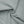 The haze blue fabric twisted to show its stretch and the soft sheen of the thin knit