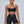 Front view on the model in the black booty shorts and matching color block sports bra