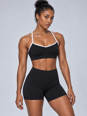 Color Block Cyber Sports Bra in black on a model, front view, white trim around the sweetheart neckline