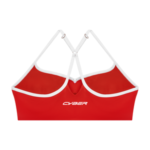Back of the red sports bra laid flat, white Y straps meeting through a ring above the CYBER band