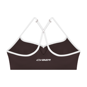Back of the brown sports bra laid flat, the white straps and trim against the dark brown knit