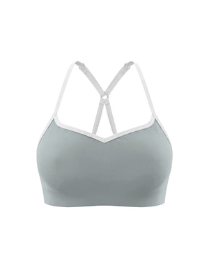 Haze blue sports bra shown at an angle from the front, the cups shaped under the white trim