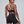 Back view on the model, thin white-trimmed straps meeting in a Y through a ring above the CYBER band