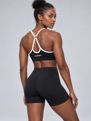 Back view on the model, thin white-trimmed straps meeting in a Y through a ring above the CYBER band