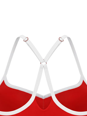 Back of the red sports bra up close, the white straps meeting in a Y through the metal ring