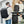 Black nylon commuter backpack with a padded back panel and a top grab handle