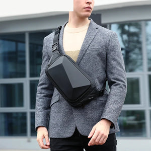 Small black chest bag with angular panels and a single zip
