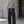 Man in a grey tank top and the Contrast Stitch Black Baggy Sweatpants, front view against a concrete wall