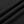 Close-up of the black polyester and cotton fleece in folds, the fabric of the contrast stitch sweatpants