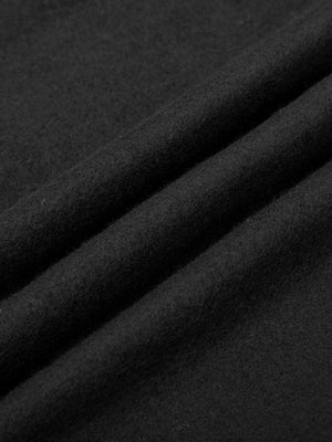 Close-up of the black polyester and cotton fleece in folds, the fabric of the contrast stitch sweatpants