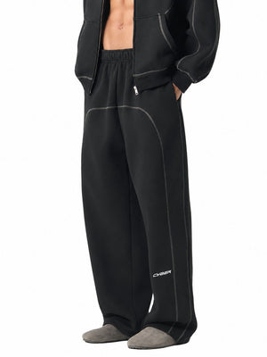Black contrast stitch sweatpants in a side three-quarter view, hand in the pocket, CYBER logo on the leg