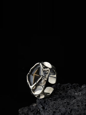 Cracking Star Y2K Ring, silver-tone cracked plates around a gold-tone star, on black lava rock
