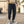 Man wearing the Cropped Cargo Cyberpunk Pants with a sweatshirt, front view, flap pocket and ankle cuffs