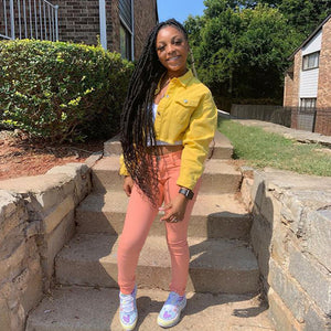 Yellow trucker jacket cropped at the waist, standing three-quarter view on outdoor steps