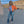 Orange Cropped Denim Y2K Jacket worn open over a white tee, front view with a hand on the hip