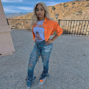 Orange Cropped Denim Y2K Jacket worn open over a white tee, front view with a hand on the hip