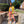Yellow cropped jean jacket worn open over a white top with coral jeans, full length front view outdoors