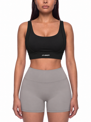 Cross Back Cyber Yoga Bra in black on a model, front view, scoop neck and a CYBER wordmark on the band