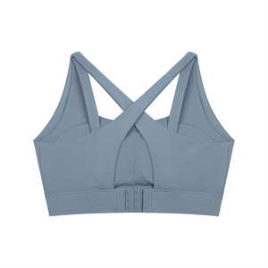 Back of the gray blue yoga bra laid flat, the X straps meeting above the keyhole opening