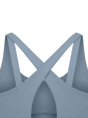 Close-up of the back, the wide straps crossing in an X over the teardrop keyhole opening