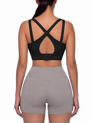 Back view on the model, wide black straps crossing in an X over a keyhole and a hook-and-eye band